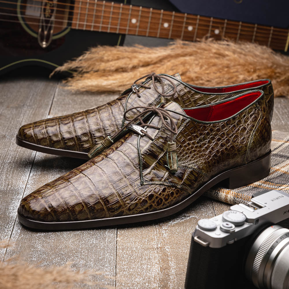 The Marco Di Milano Lacio WoodGreen men's dress shoes, made from genuine caiman crocodile leather with laces, red interior lining, and branded soles, are elegantly displayed against a white background.