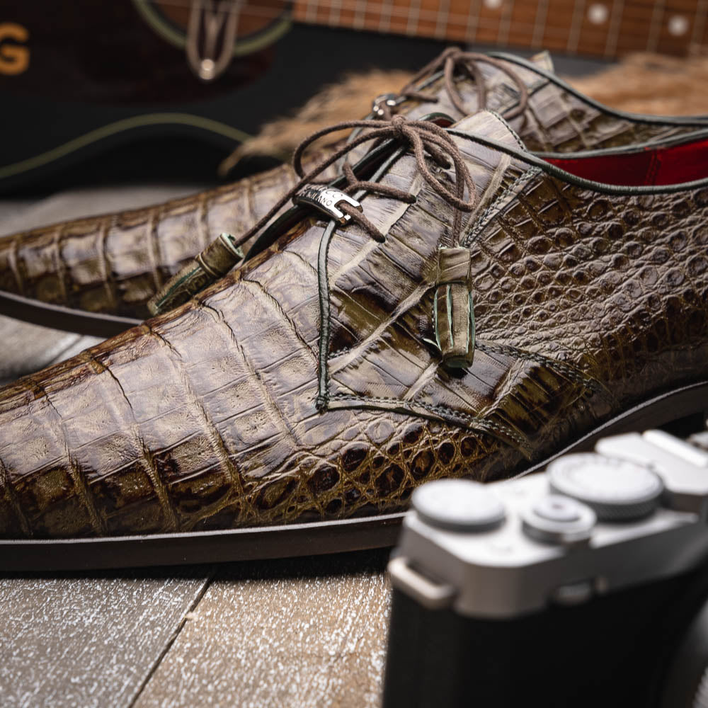 The Marco Di Milano Lacio WoodGreen men's dress shoes, made from genuine caiman crocodile leather with laces, red interior lining, and branded soles, are elegantly displayed against a white background.