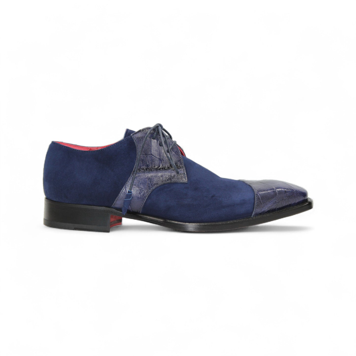 The Fennix Landon Navy by Fennix of Italy showcases Italian craftsmanship with luxurious blue suede and leather, a low heel, cap toe, and red lining—an elegant shoe displayed in profile on a white background.