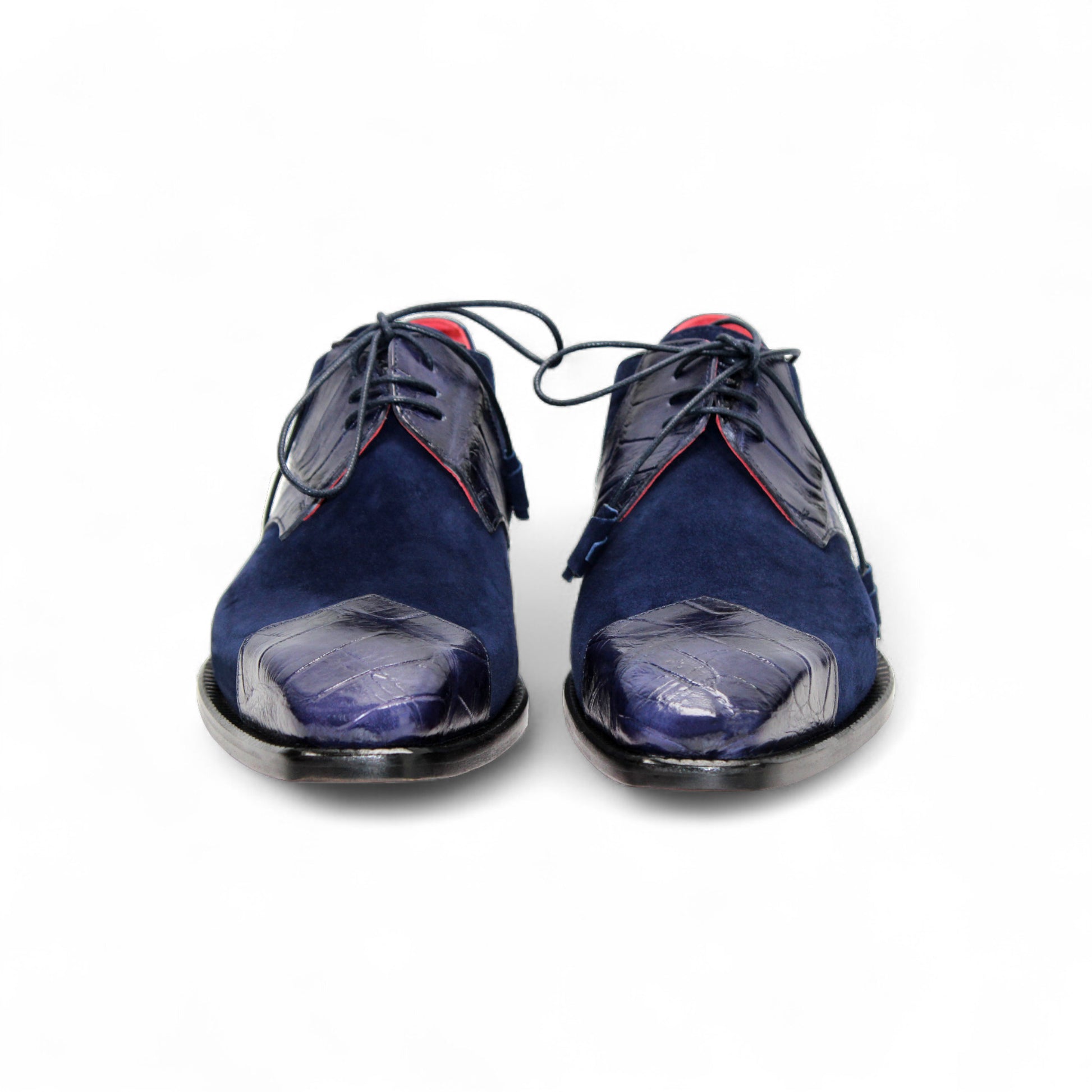 The Fennix Landon Navy by Fennix of Italy showcases Italian craftsmanship with luxurious blue suede and leather, a low heel, cap toe, and red lining—an elegant shoe displayed in profile on a white background.