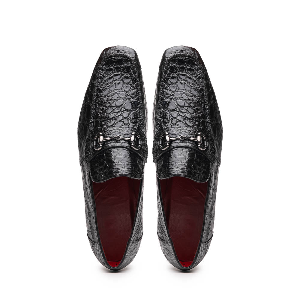 A pair of Marco Di Milano Landro Black crocodile-pattern luxury loafers with metal bit detail: one shoe stands upright, the other lies on its side displaying the tan sole labeled "Marco Di Milano.