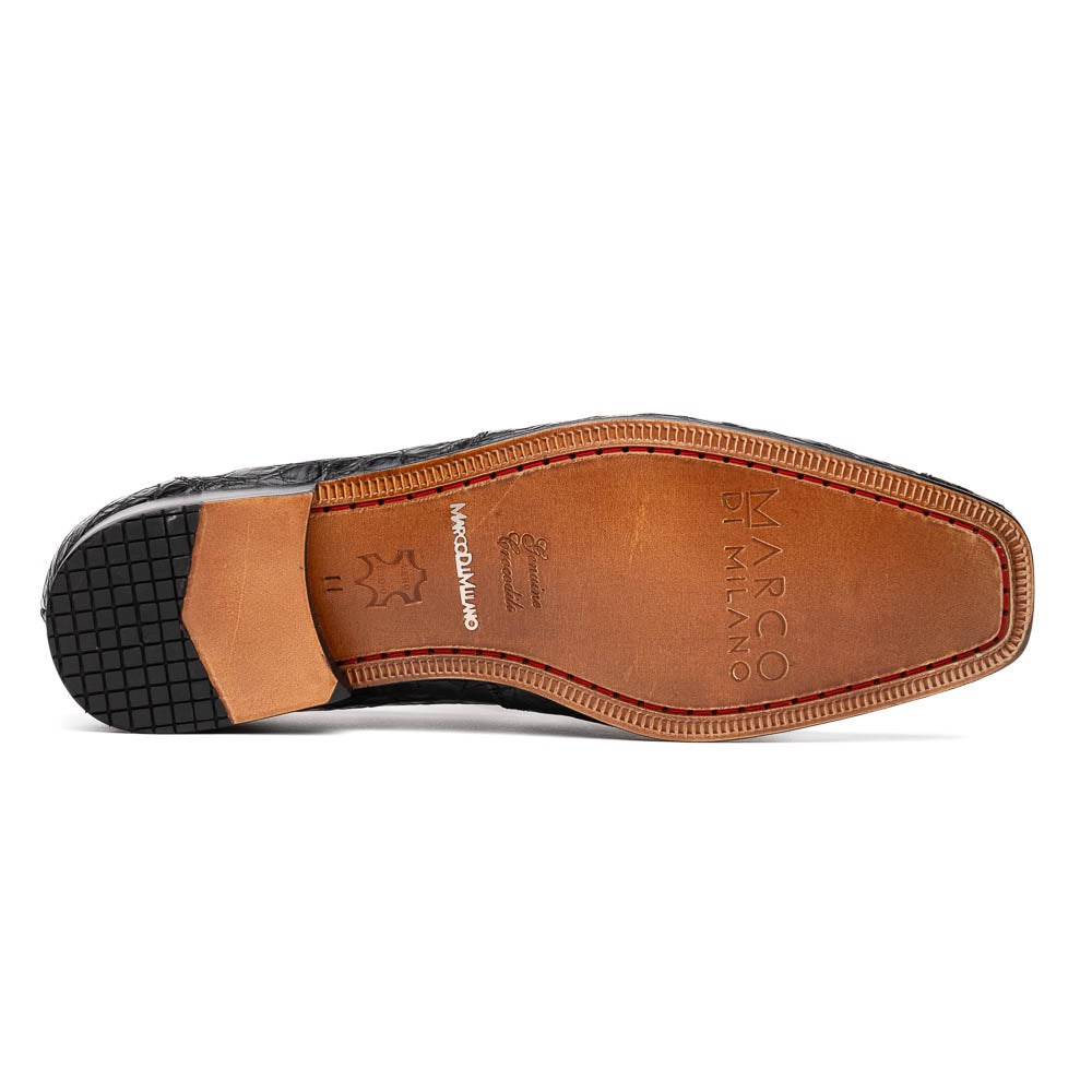 A pair of Marco Di Milano Landro Black crocodile-pattern luxury loafers with metal bit detail: one shoe stands upright, the other lies on its side displaying the tan sole labeled "Marco Di Milano.