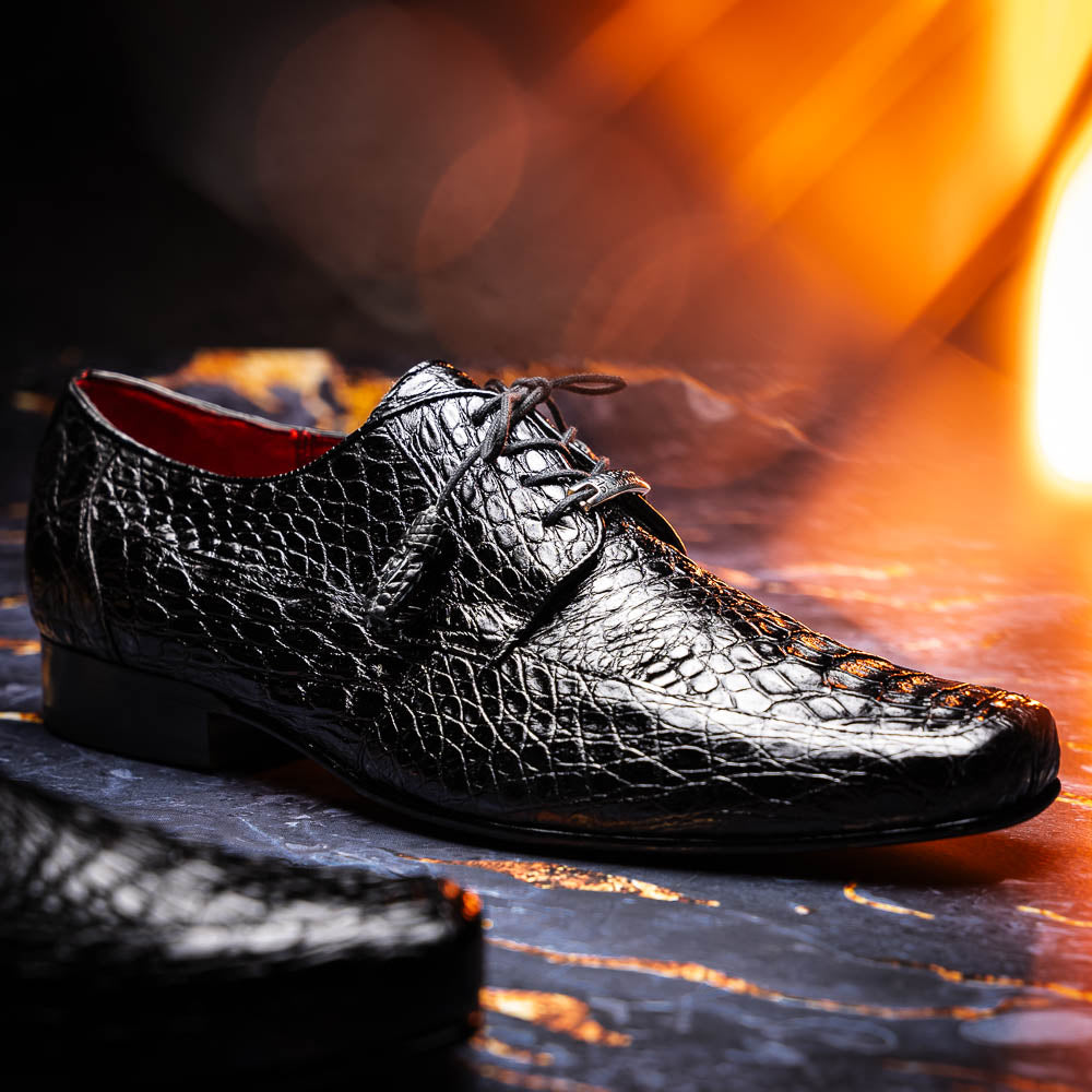 A pair of Marco Di Milano Leonardo Black luxury derby shoes in genuine caiman crocodile leather—one shoe upright, the other showing the tan sole with "Marco di Milano" text.