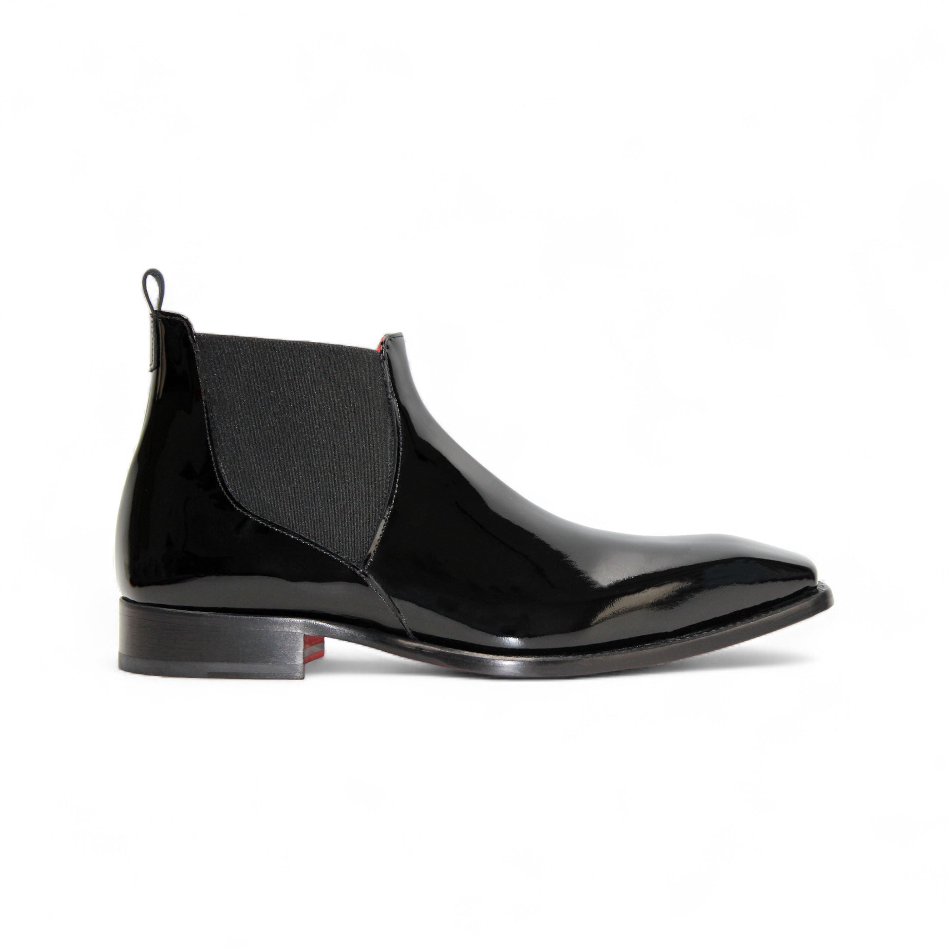 The Emilio Franco Leonardo Black is a polished Italian patent leather Chelsea boot with an elastic side panel and low heel, shown in profile against a white background—classic elegance from Emilio Franco.