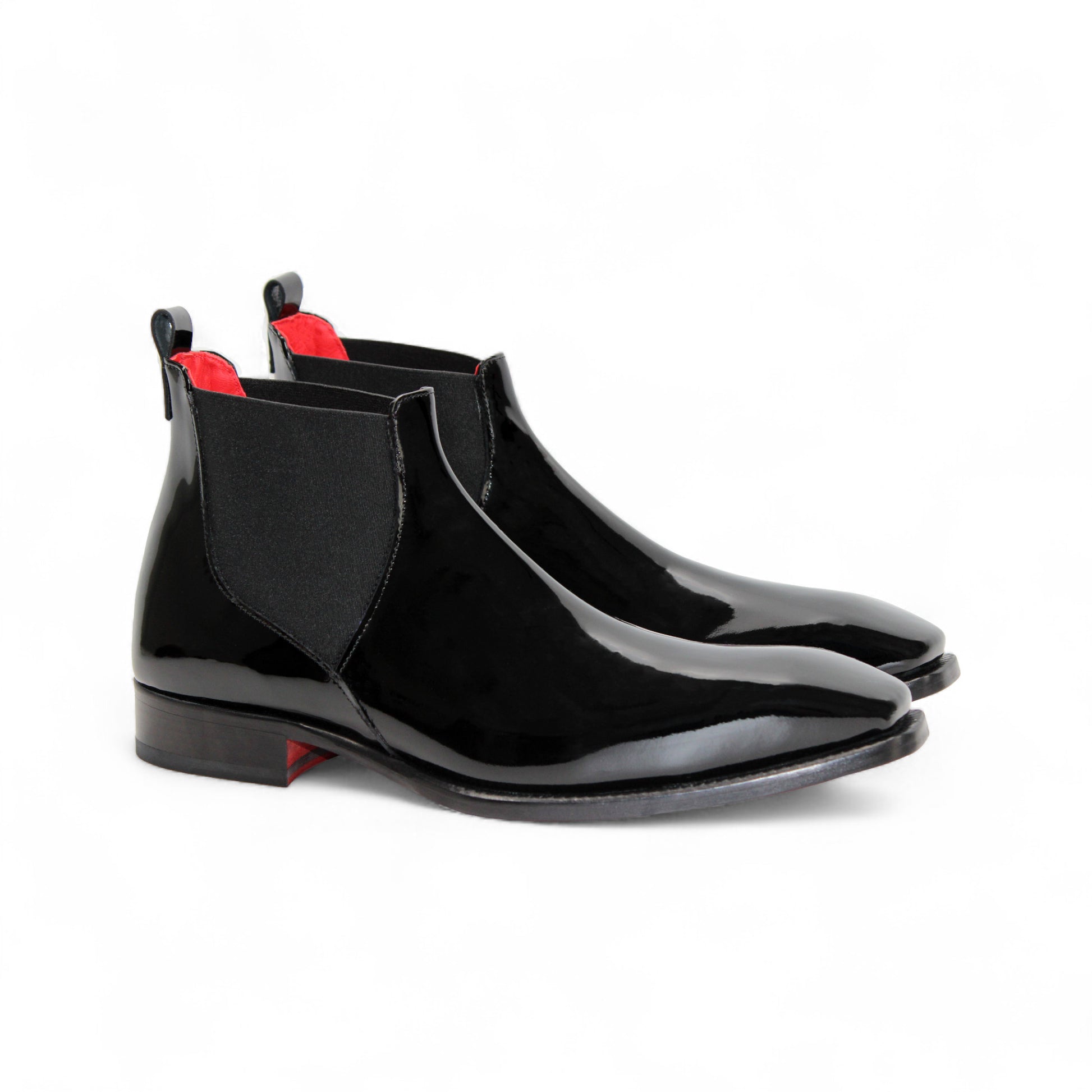 The Emilio Franco Leonardo Black is a polished Italian patent leather Chelsea boot with an elastic side panel and low heel, shown in profile against a white background—classic elegance from Emilio Franco.
