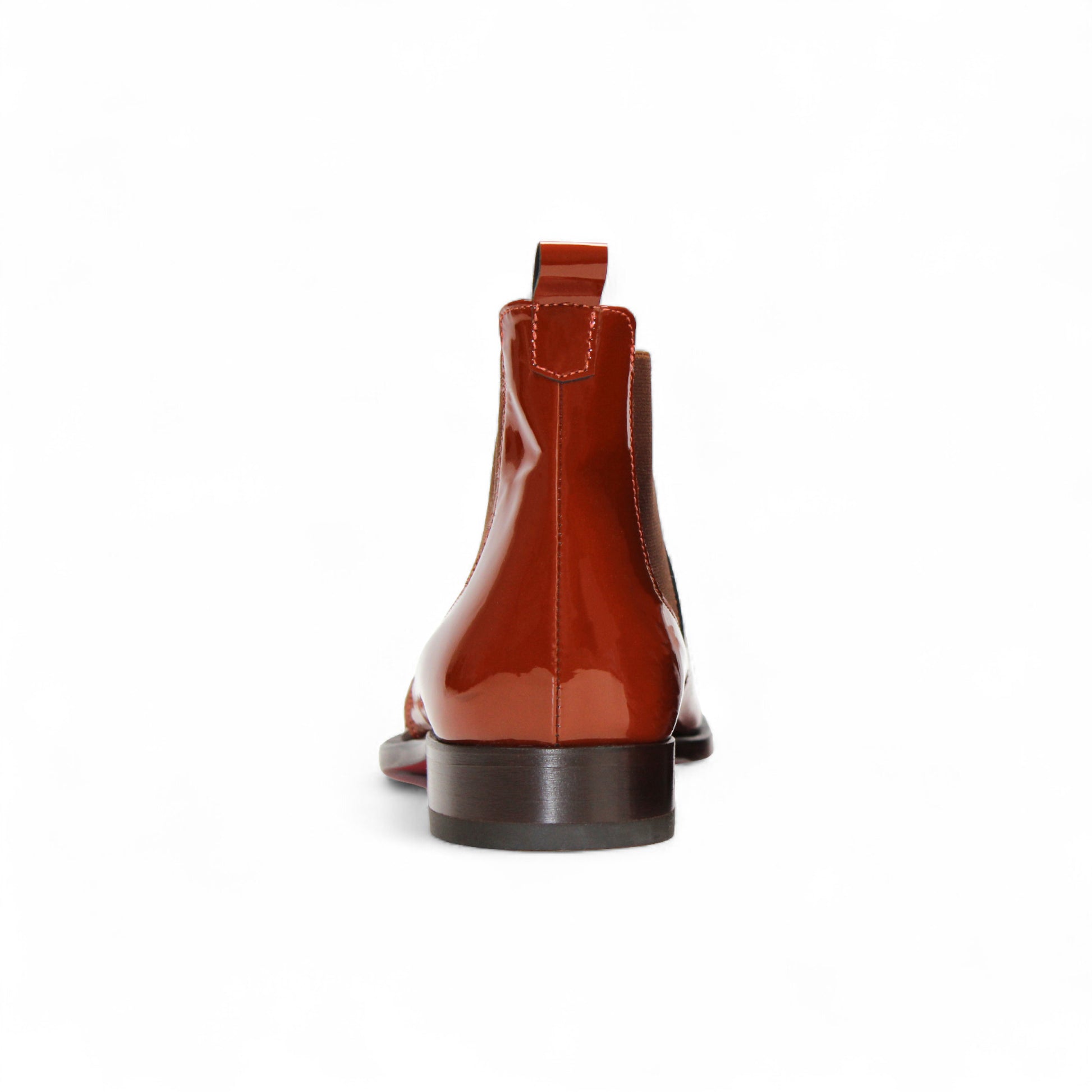 The Emilio Franco Leonardo Brandy is a shiny brown leather Chelsea boot with an elastic side panel, pull tab, and low heel by Emilio Franco, displayed on a white background.