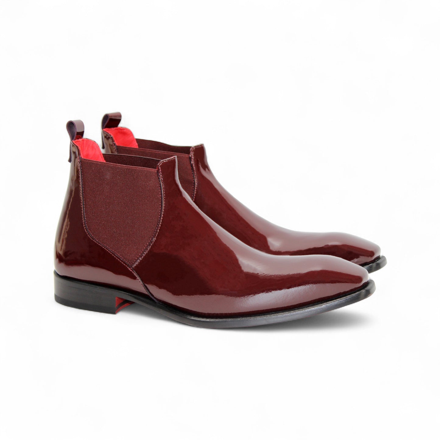 The Emilio Franco Leonardo Burgundy is a shiny Chelsea boot with Italian craftsmanship, a low black heel, and elastic side panels, photographed on a white background.