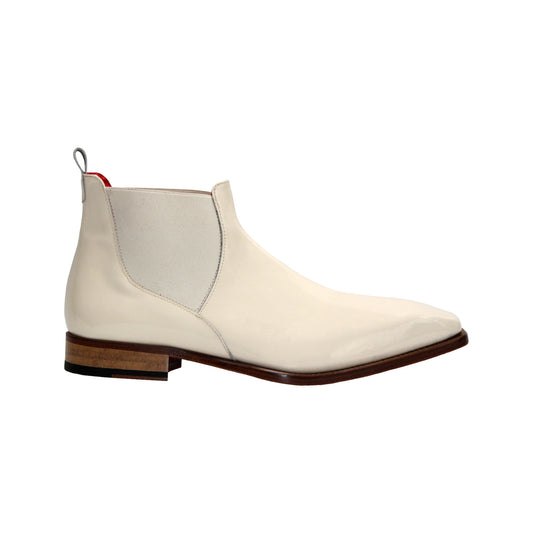 The Emilio Franco Leonardo Cream is a cream leather Chelsea boot with a low wooden heel, elastic side panel, and back pull tab, highlighting Italian craftsmanship. Shown in profile on a white background.