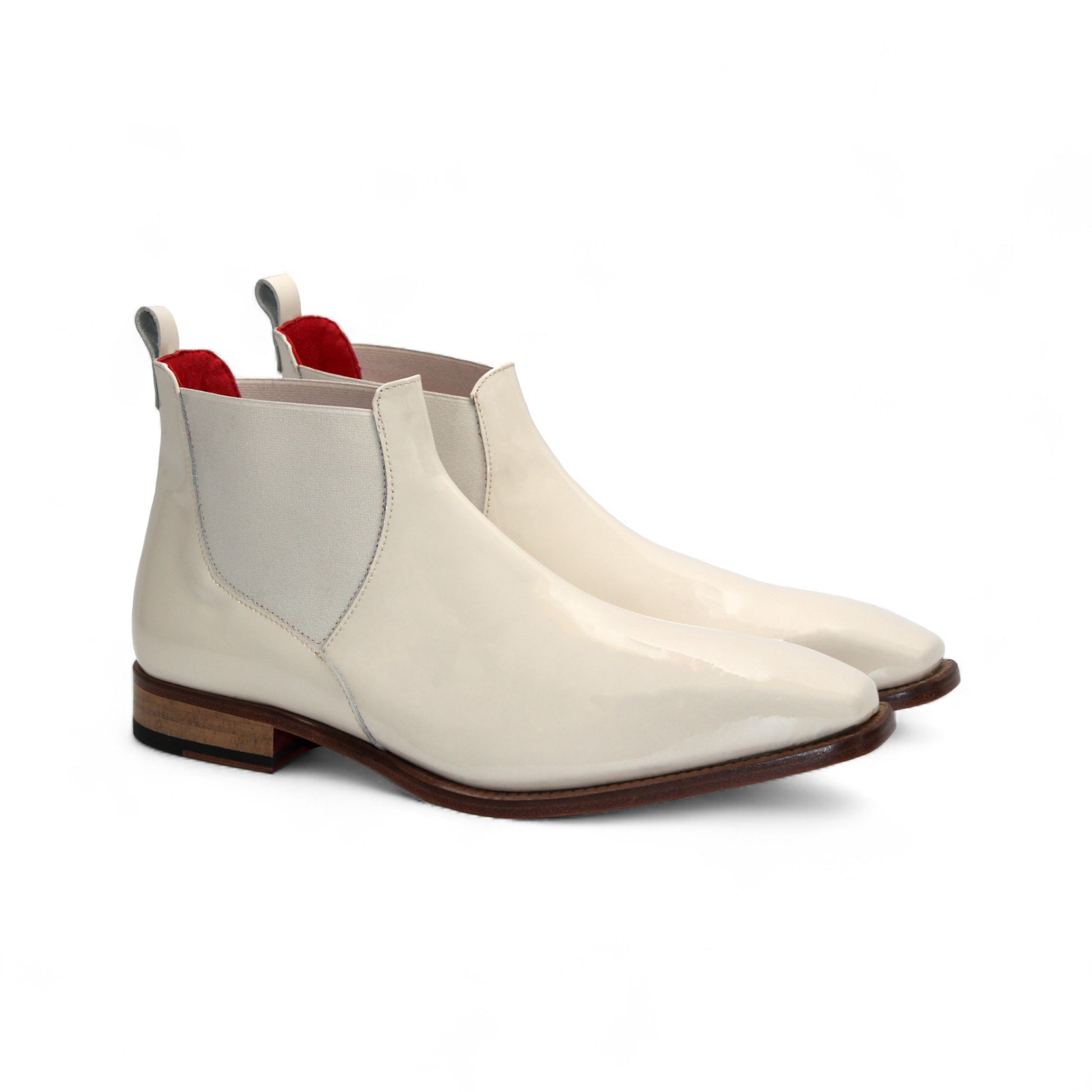 The Emilio Franco Leonardo Cream is a cream leather Chelsea boot with a low wooden heel, elastic side panel, and back pull tab, highlighting Italian craftsmanship. Shown in profile on a white background.