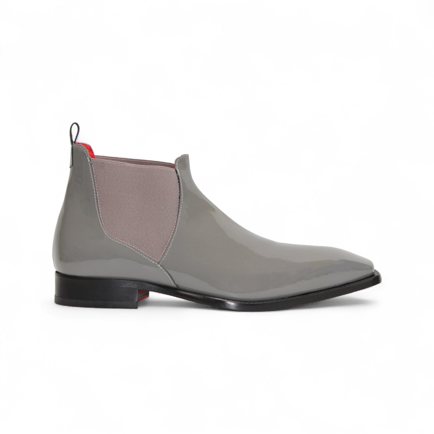 The Emilio Franco Leonardo Grey is a glossy Italian patent leather Chelsea boot with side elastic panels, low black heel, and red accents on the pull tab and lining—luxury formal footwear by Emilio Franco, shown on a white background.