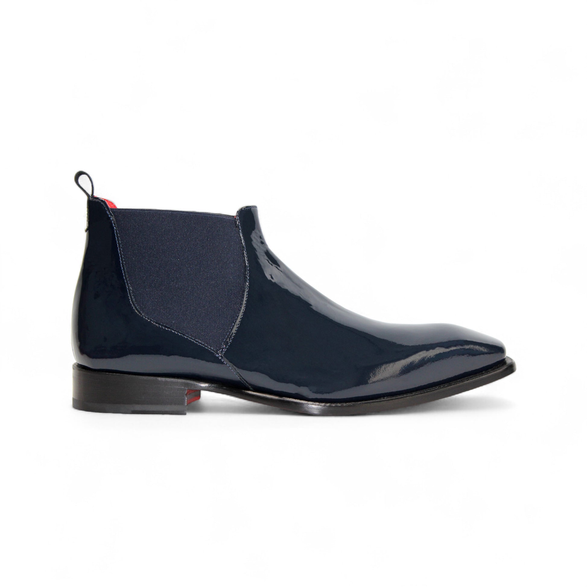 The Emilio Franco Leonardo Navy is a sleek Chelsea boot in navy Italian patent leather with an elastic side panel, low heel, leather sole, and pull tab, displayed in profile against a plain white background.