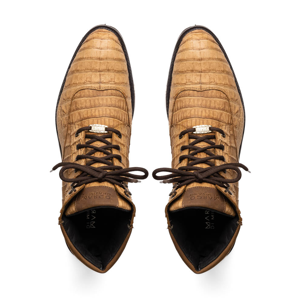 The Leoni Oil Orix by Marco Di Milano features tan crocodile-patterned leather lace-up boots with brown rubber soles, showcased upright and sideways to highlight the tread—a refined choice in luxury men's footwear.