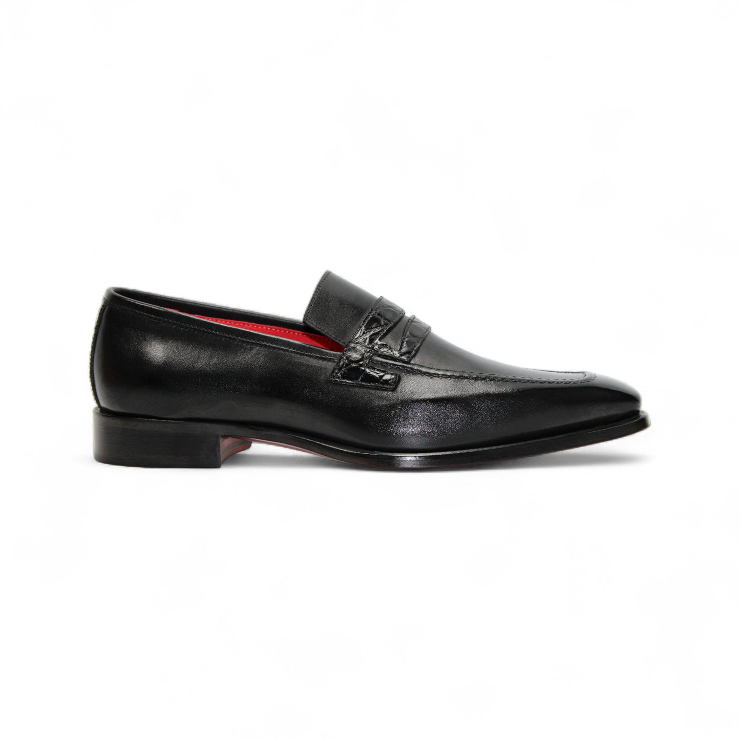 The Fennix Liam Black by Fennix of Italy is a black leather loafer with a low heel and red interior lining, showcasing Italian craftsmanship, displayed in side profile on a white background.