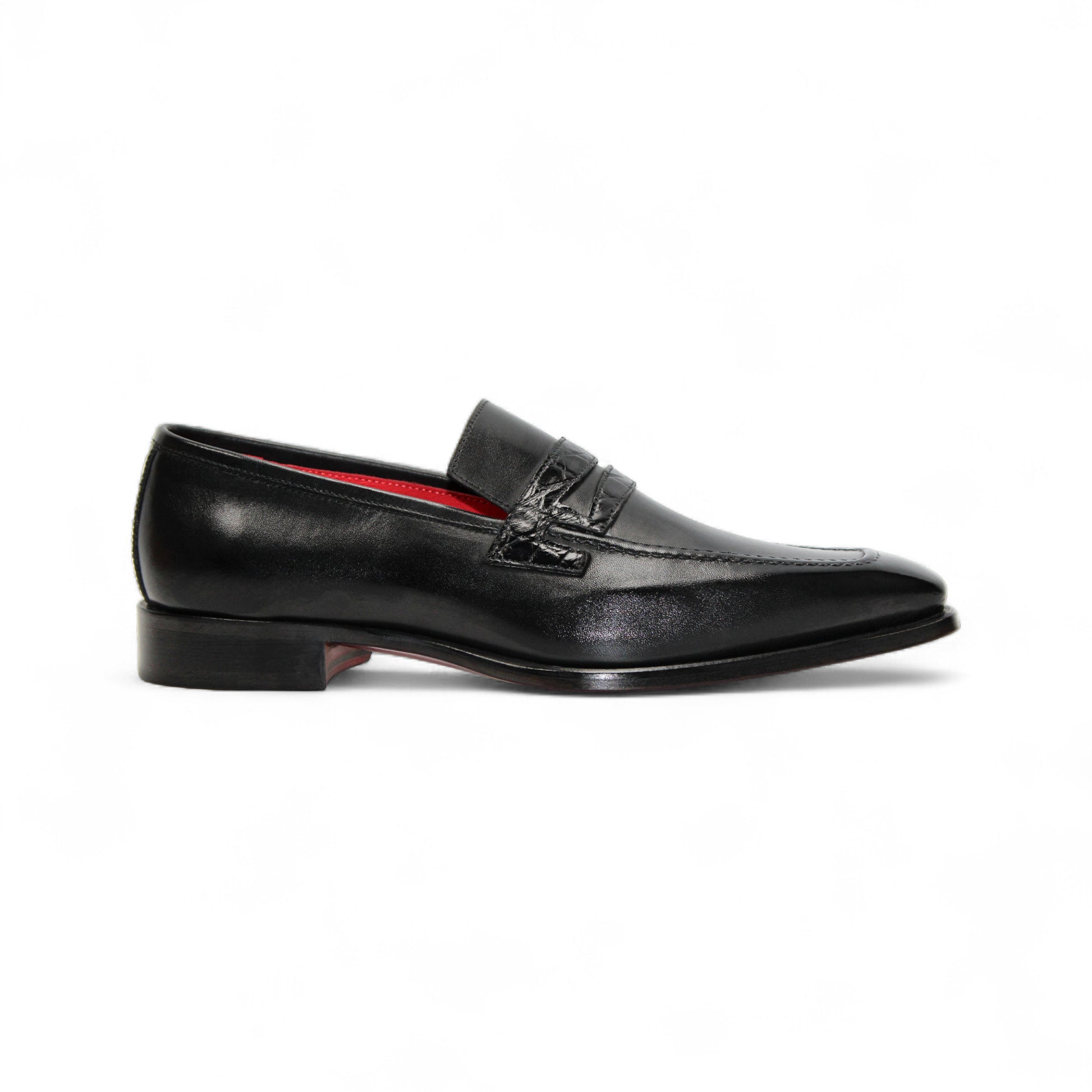 The Fennix Liam Black by Fennix of Italy is a black leather loafer with a low heel and red interior lining, showcasing Italian craftsmanship, displayed in side profile on a white background.