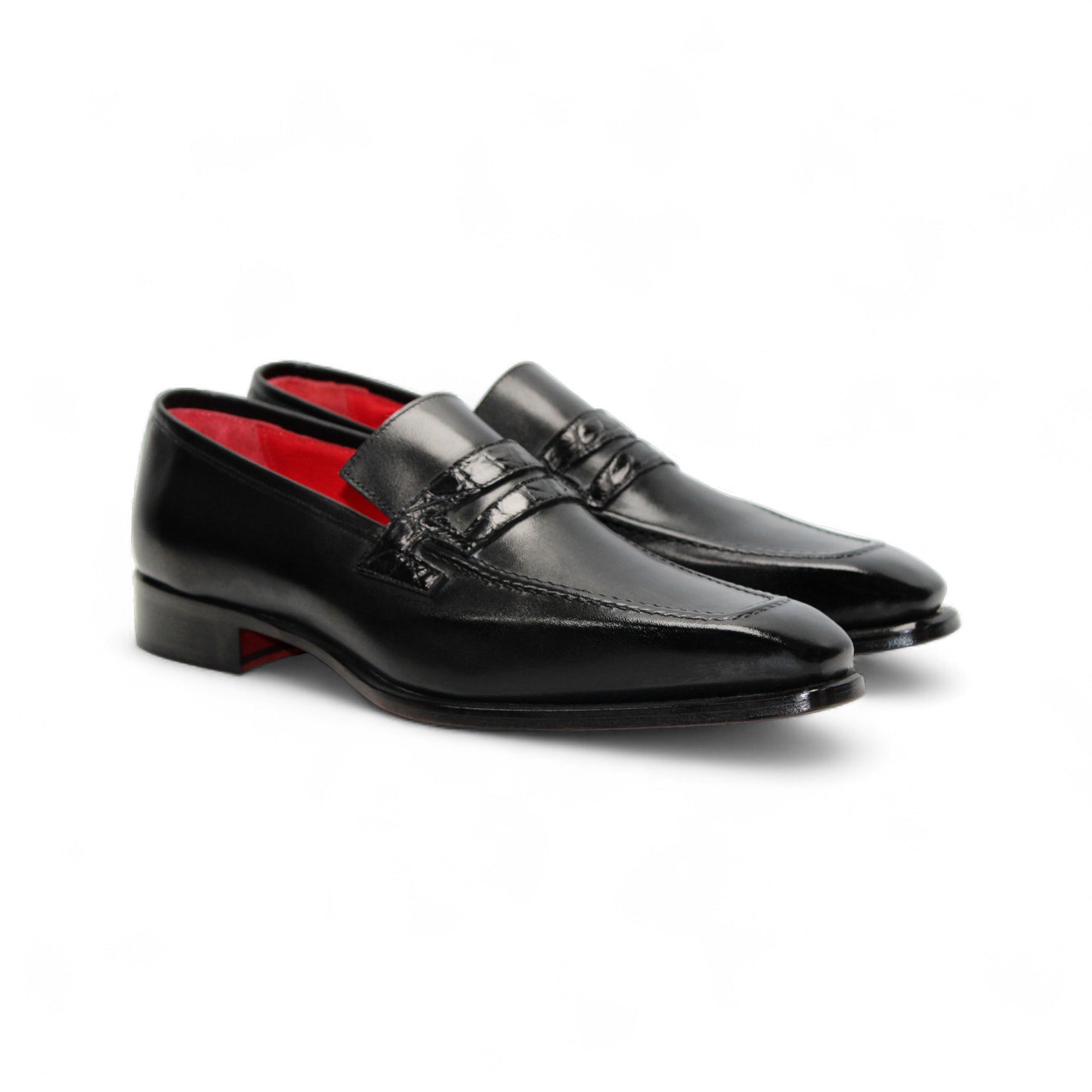 The Fennix Liam Black by Fennix of Italy is a black leather loafer with a low heel and red interior lining, showcasing Italian craftsmanship, displayed in side profile on a white background.