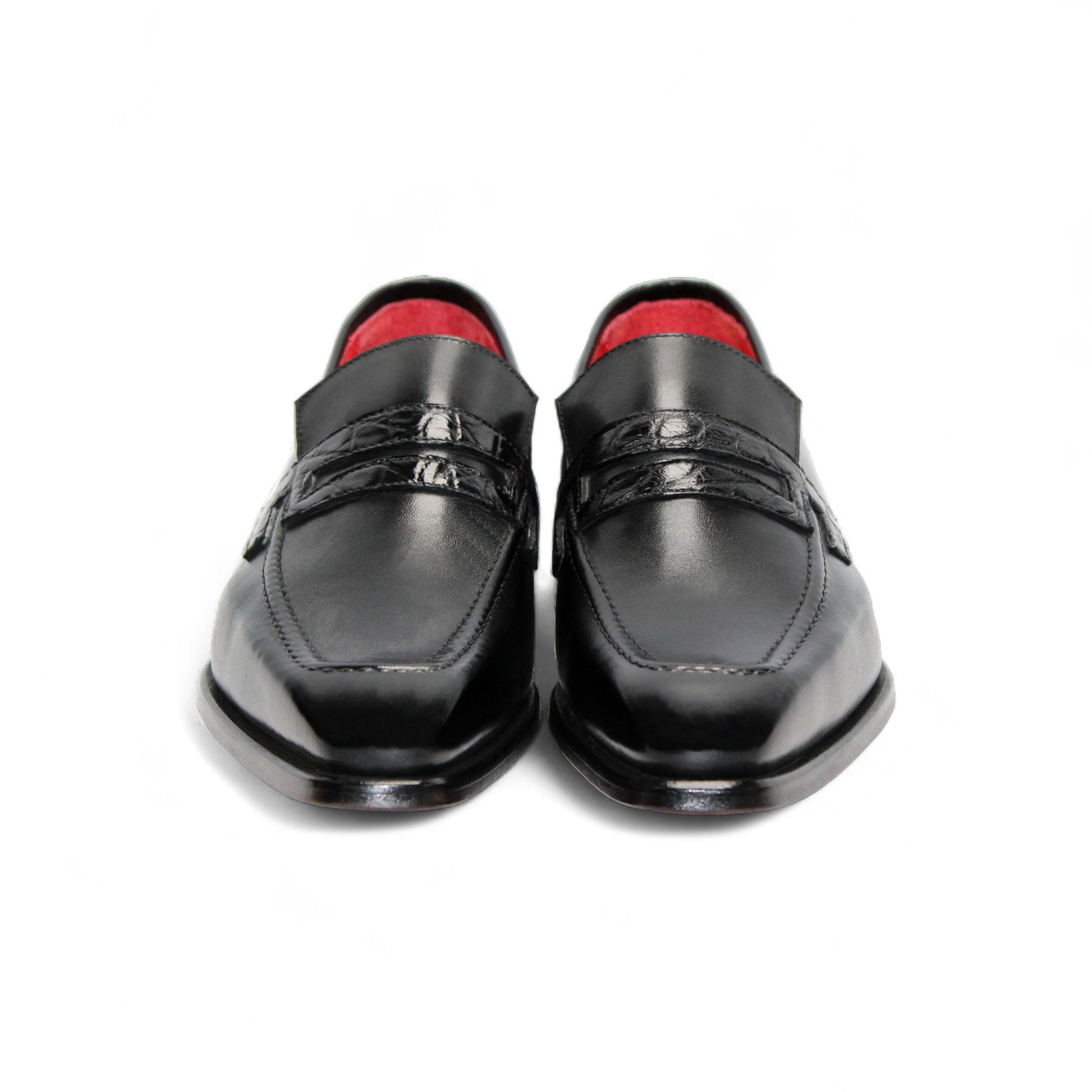 The Fennix Liam Black by Fennix of Italy is a black leather loafer with a low heel and red interior lining, showcasing Italian craftsmanship, displayed in side profile on a white background.