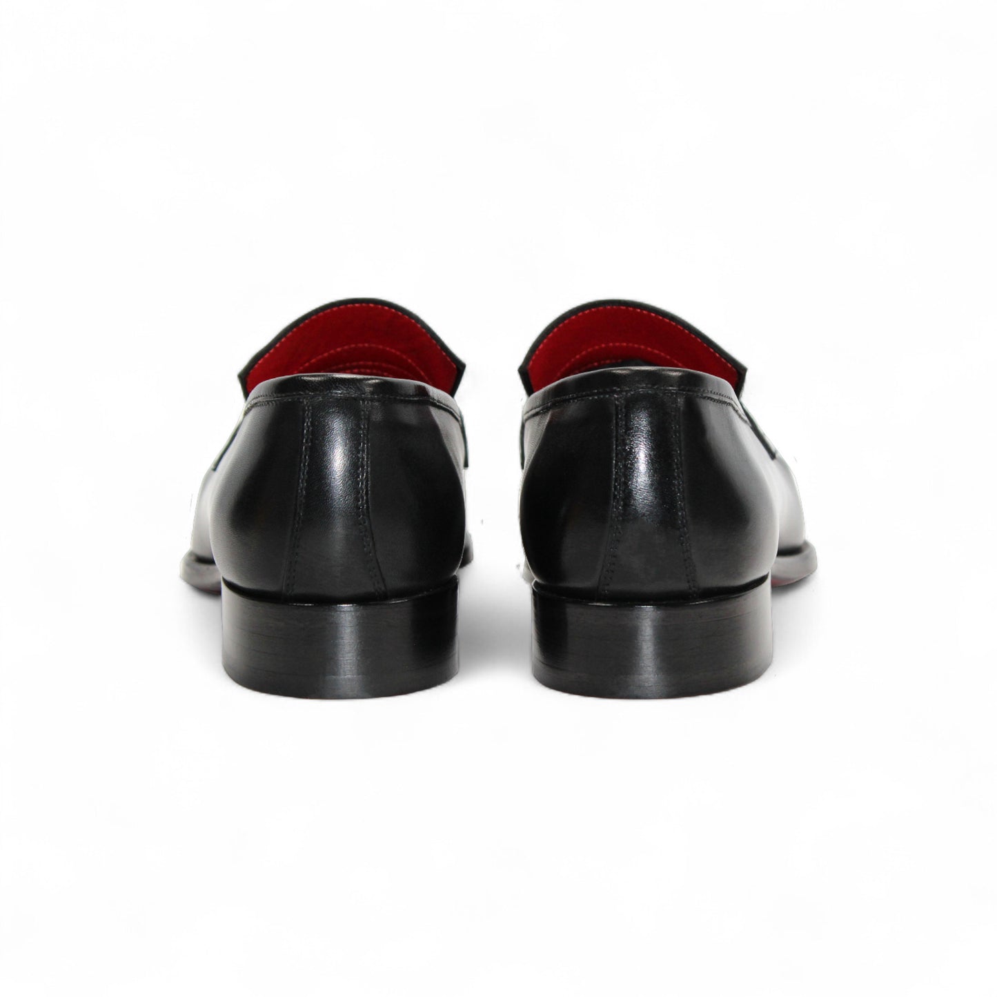 The Fennix Liam Black by Fennix of Italy is a black leather loafer with a low heel and red interior lining, showcasing Italian craftsmanship, displayed in side profile on a white background.
