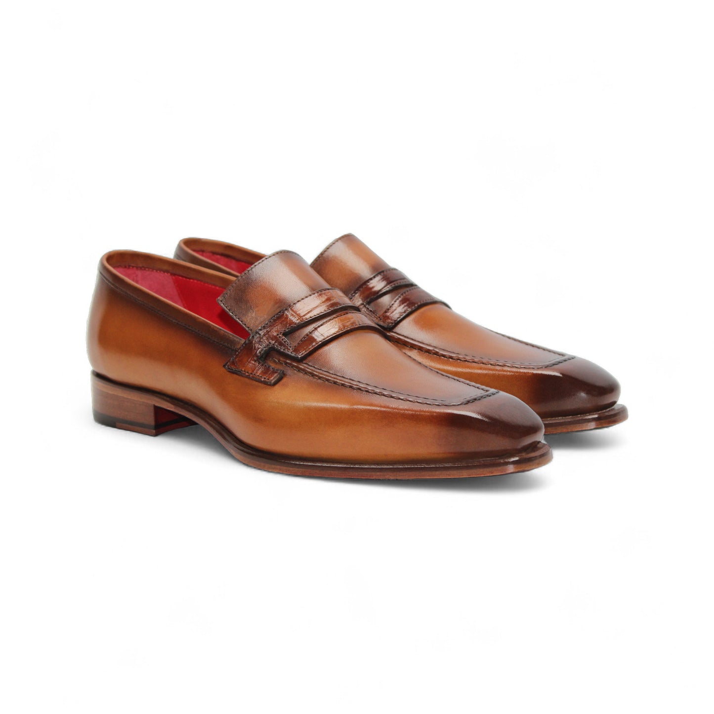 The Fennix of Italy Fennix Liam Cognac is a brown leather loafer with a low heel, penny strap, and red interior lining, expertly crafted in Italy and shown in side profile on a white background.