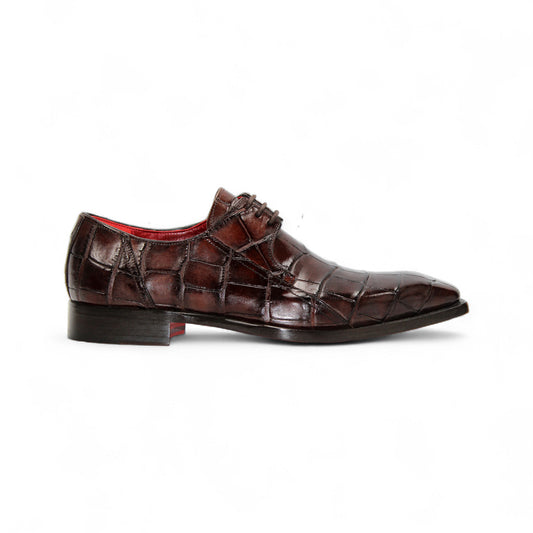 The Fennix of Italy Fennix Logan Chocolate is a luxury men's shoe in dark brown genuine alligator leather with a crocodile pattern, red interior lining, and low heel, displayed in profile on a white background.