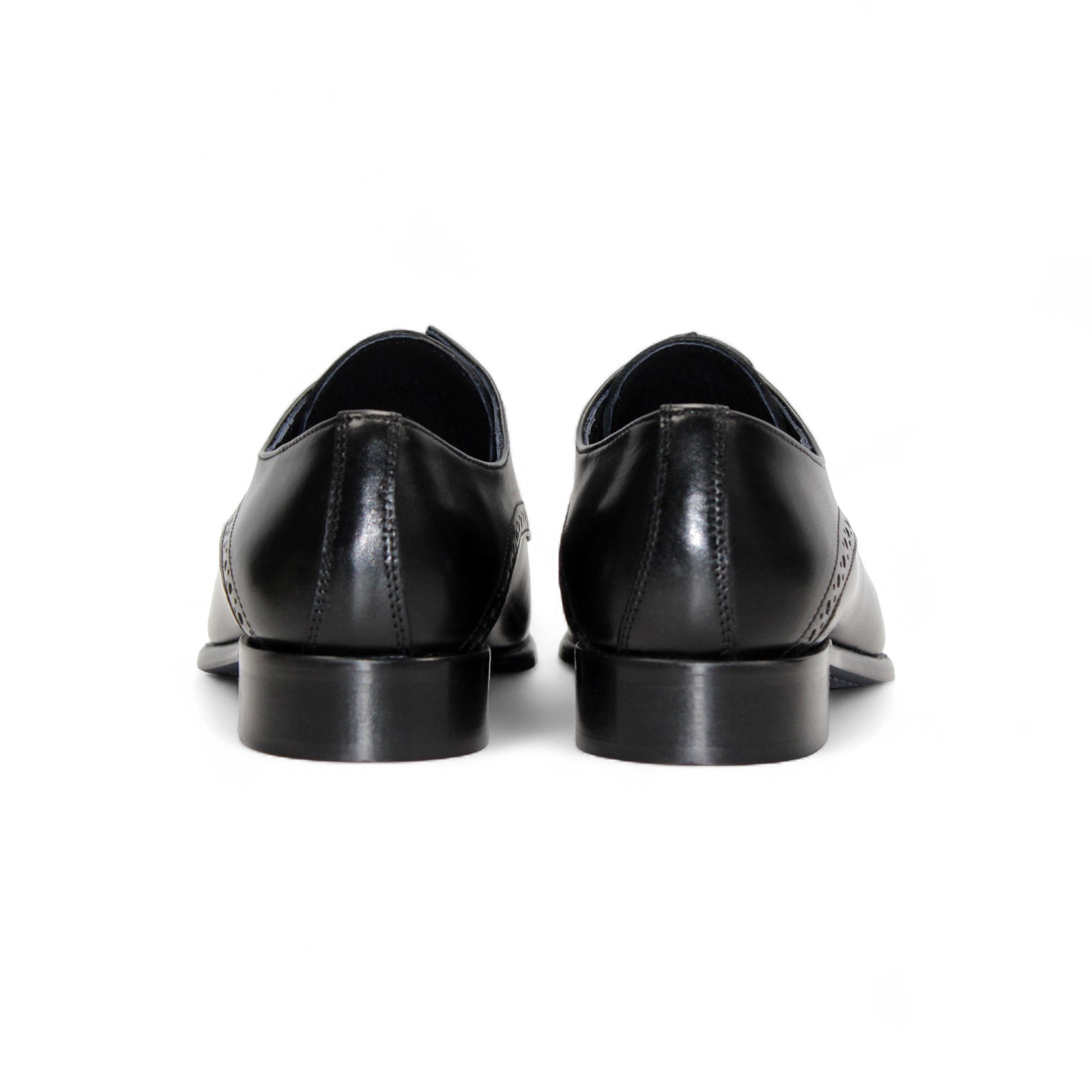 The Duca Di Matiste Duca Lombardi Black is an Italian-made leather dress shoe with brogue details, cap toe, closed lacing, low heel, and leather sole. Shown in profile on a white background.