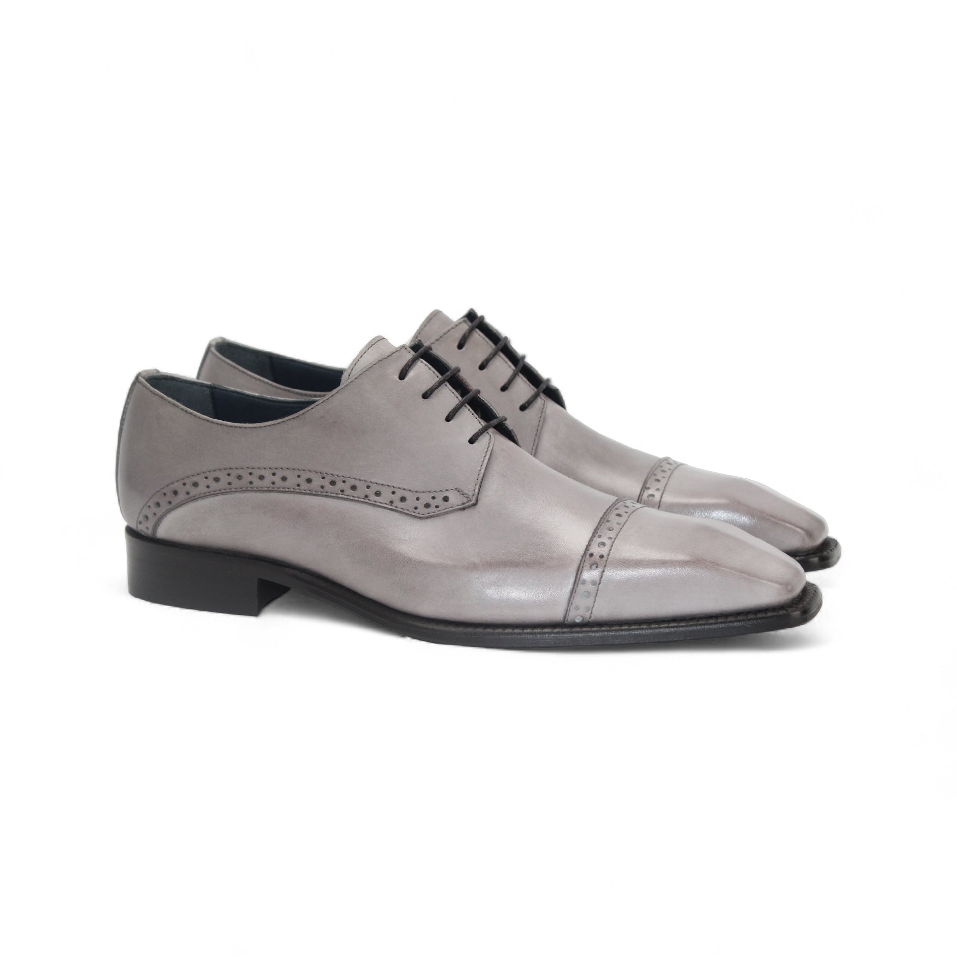 The Duca Lombardi Light Grey by Duca Di Matiste is an Italian-made genuine leather dress shoe with black laces, a low heel, and decorative perforations on the side and toe cap, shown against a white background.