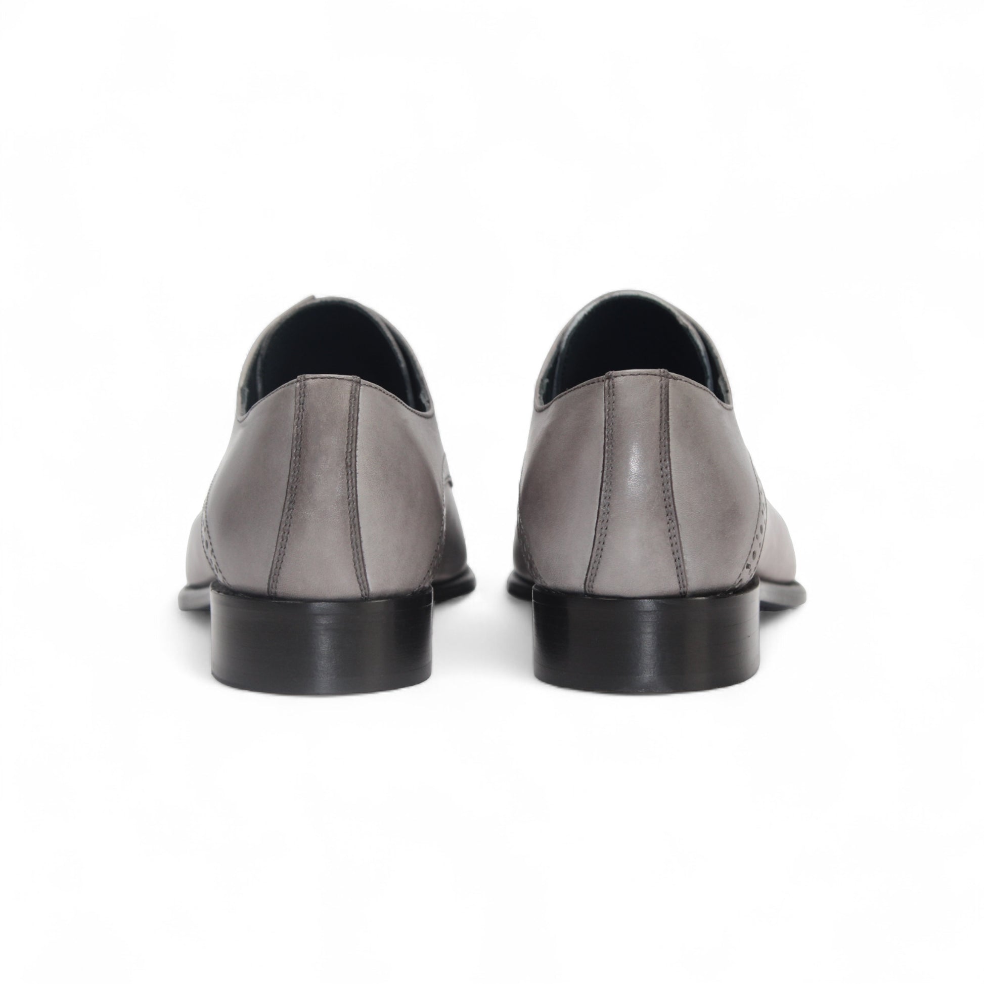 The Duca Lombardi Light Grey by Duca Di Matiste is an Italian-made genuine leather dress shoe with black laces, a low heel, and decorative perforations on the side and toe cap, shown against a white background.