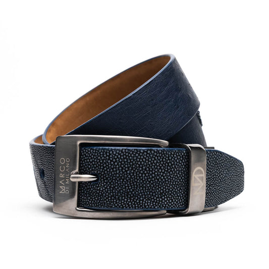 The Lucca Belt Navy / Black by Marco Di Milano is a navy blue leather belt with a metallic buckle and embossed logo details, elegantly coiled against a white background—a refined piece from their luxury collection.