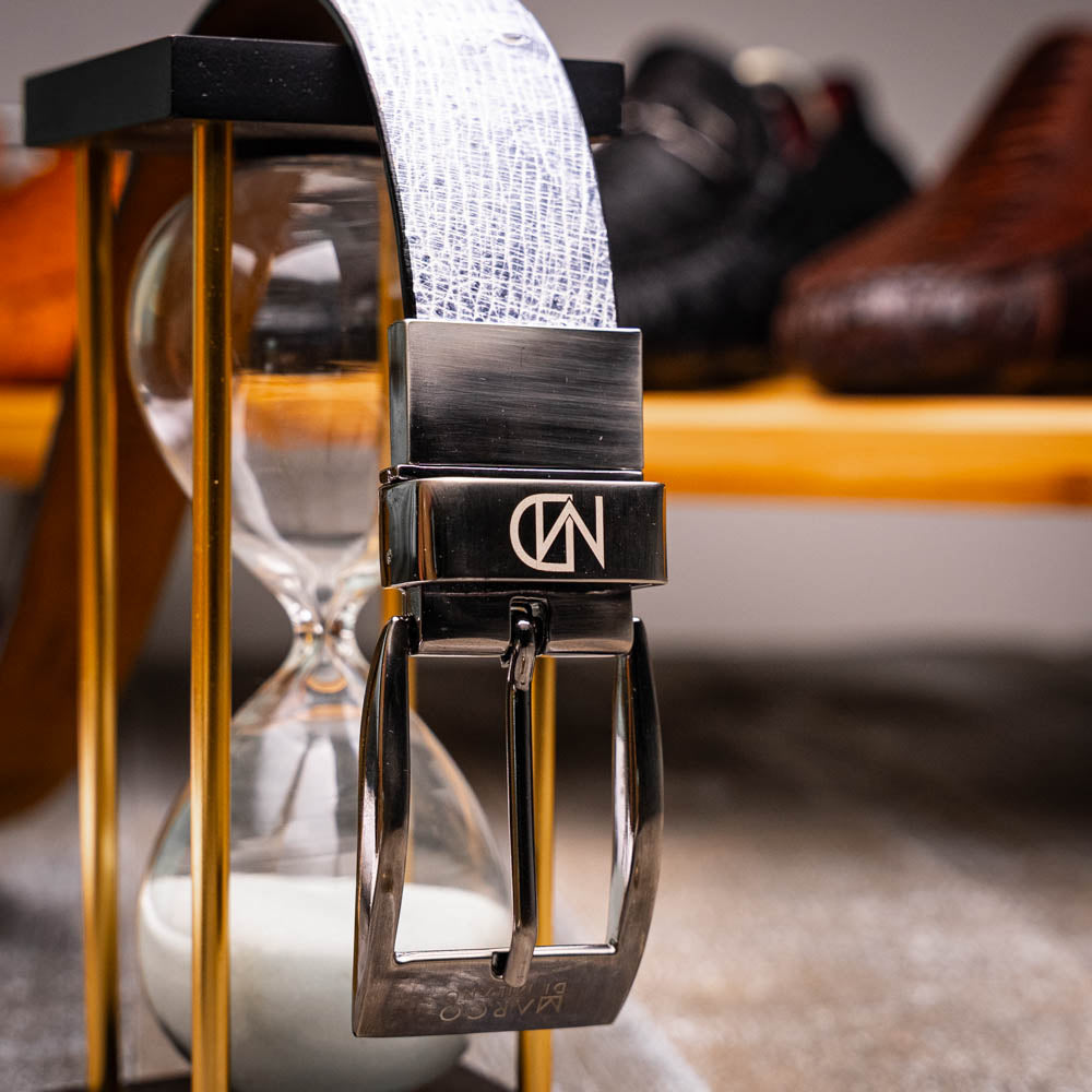 A Marco Di Milano Lucca Belt in Newspaper/Black, crafted with genuine leather and a distinctive texture, is wrapped around another belt to highlight the refined elegance of these luxury accessories.
