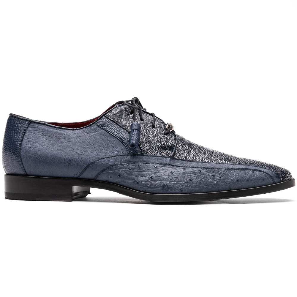 The Lucca Navy by Marco Di Milano: dark blue ostrich dress derby shoes with black soles, lace-up closures, and a textured finish. One shoe stands upright while the other lays on its side, highlighting hand-painted details.