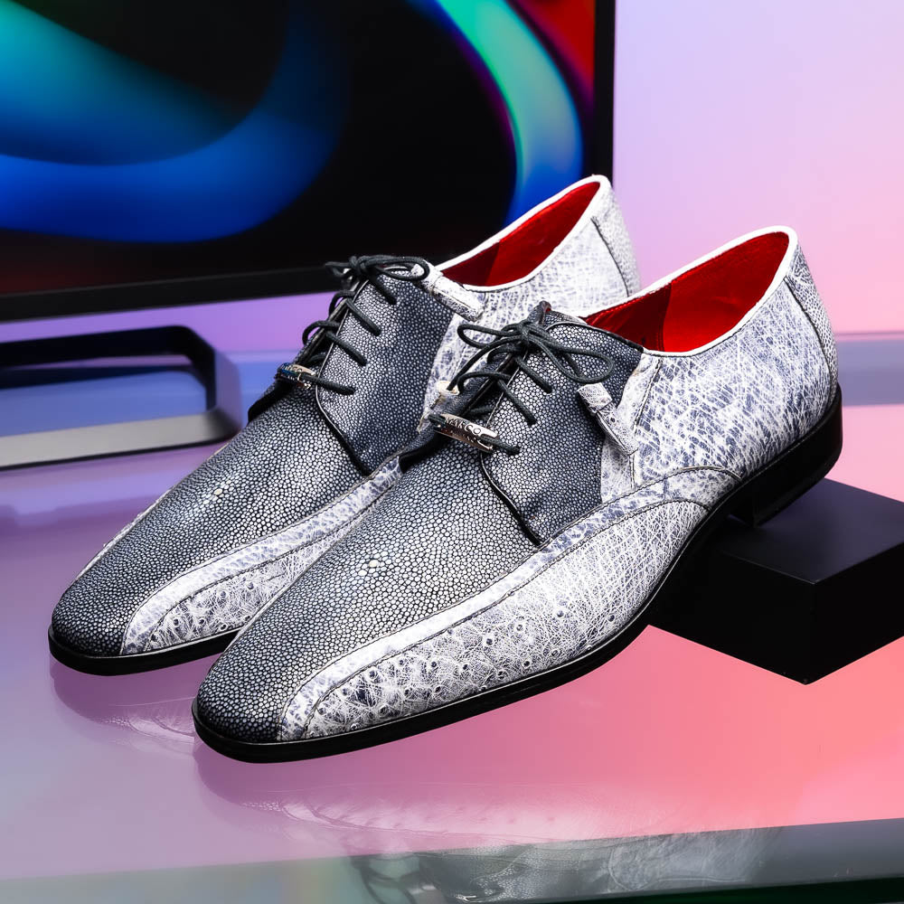 The Lucca Newspaper by Marco Di Milano are luxury men's dress shoes crafted from genuine stingray, featuring a textured gray and black upper, black laces, red inner lining, and brown leather soles with branded detail.