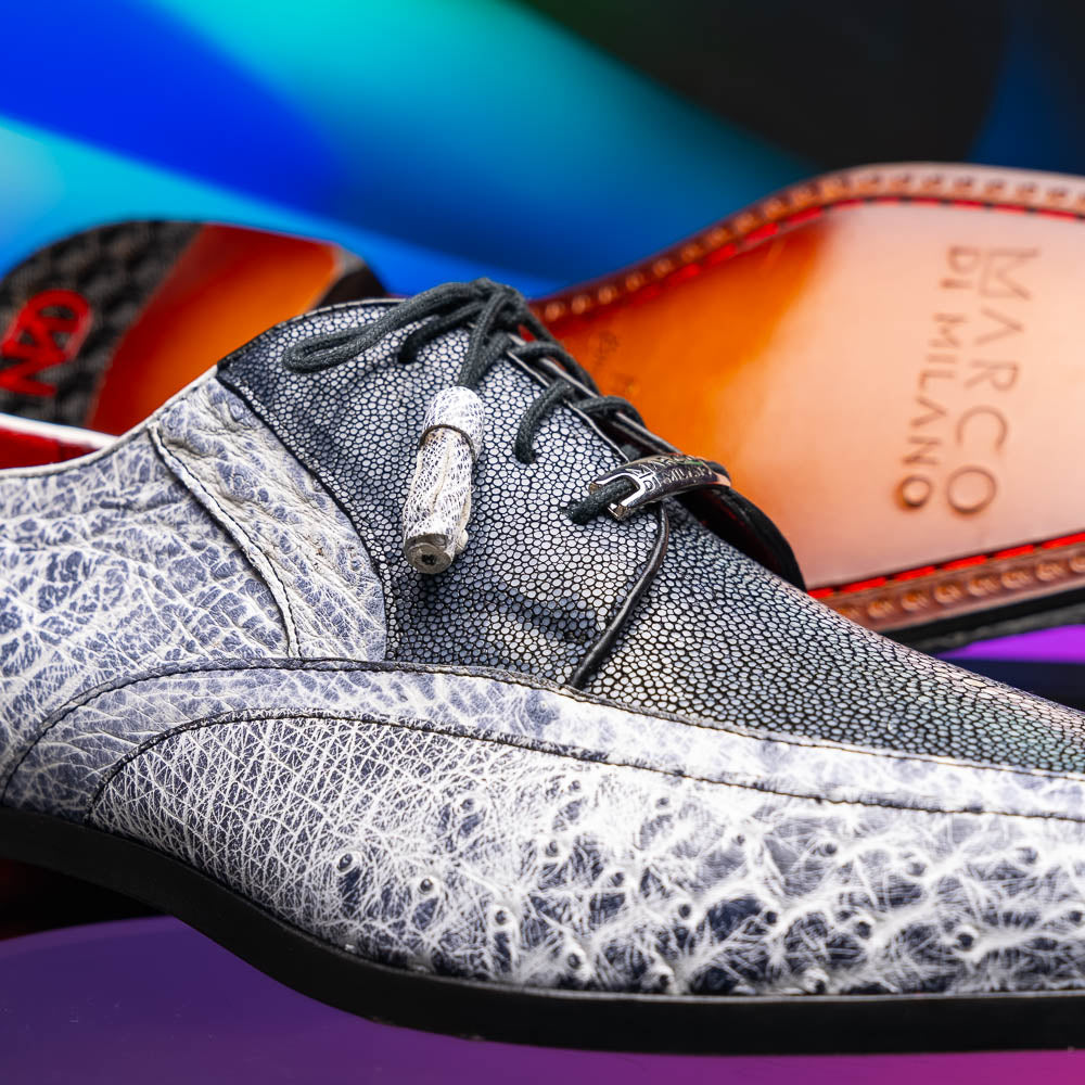 The Lucca Newspaper by Marco Di Milano are luxury men's dress shoes crafted from genuine stingray, featuring a textured gray and black upper, black laces, red inner lining, and brown leather soles with branded detail.