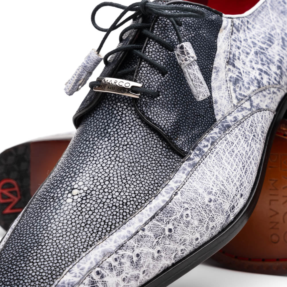 The Lucca Newspaper by Marco Di Milano are luxury men's dress shoes crafted from genuine stingray, featuring a textured gray and black upper, black laces, red inner lining, and brown leather soles with branded detail.
