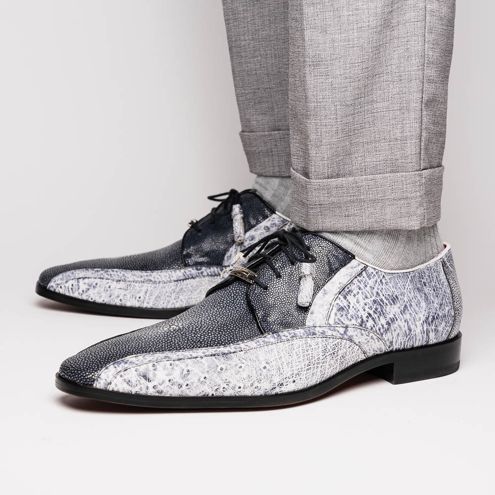 The Lucca Newspaper by Marco Di Milano are luxury men's dress shoes crafted from genuine stingray, featuring a textured gray and black upper, black laces, red inner lining, and brown leather soles with branded detail.