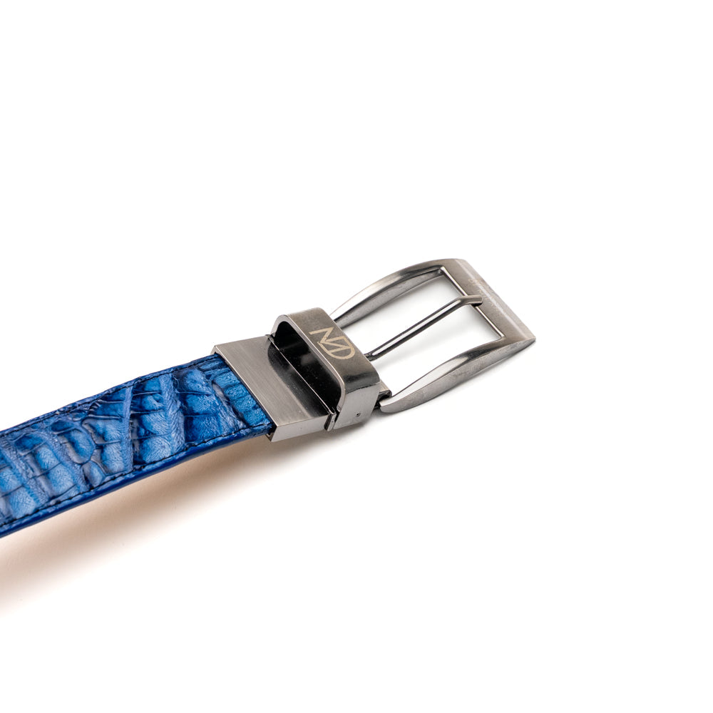 The Luciano Belt in Blue and Brandy by Marco Di Milano—both crafted from genuine caiman leather and adorned with silver buckles—are elegantly coiled together against a white background.
