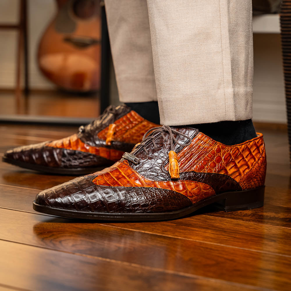 A pair of Marco Di Milano Luciano Brown / Cognac dress shoes with a pointed toe, lace-up closure, and embossed sole branding—ideal for elevating your luxury men's footwear collection.