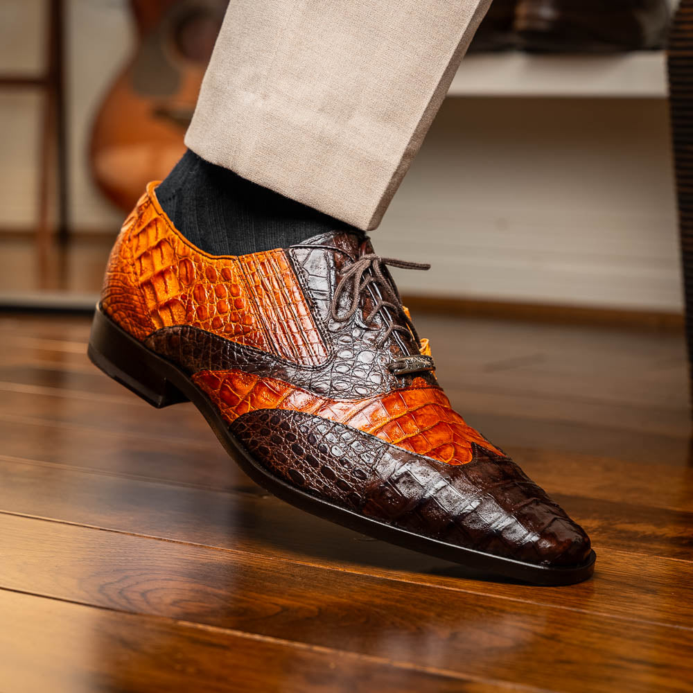 A pair of Marco Di Milano Luciano Brown / Cognac dress shoes with a pointed toe, lace-up closure, and embossed sole branding—ideal for elevating your luxury men's footwear collection.