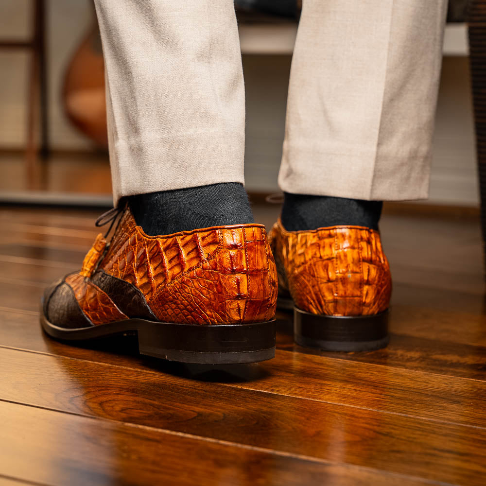 A pair of Marco Di Milano Luciano Brown / Cognac dress shoes with a pointed toe, lace-up closure, and embossed sole branding—ideal for elevating your luxury men's footwear collection.