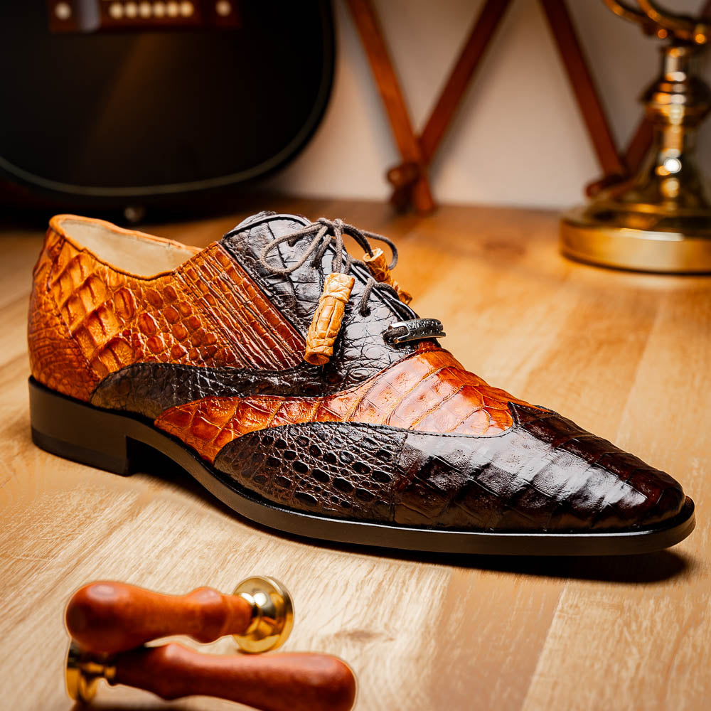 A pair of Marco Di Milano Luciano Brown / Cognac dress shoes with a pointed toe, lace-up closure, and embossed sole branding—ideal for elevating your luxury men's footwear collection.
