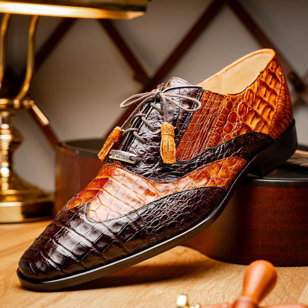 A pair of Marco Di Milano Luciano Brown / Cognac dress shoes with a pointed toe, lace-up closure, and embossed sole branding—ideal for elevating your luxury men's footwear collection.