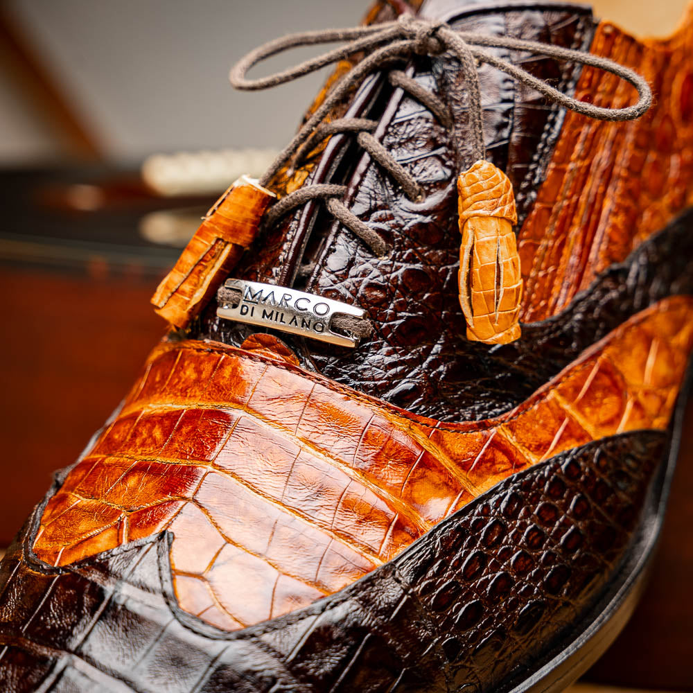 A pair of Marco Di Milano Luciano Brown / Cognac dress shoes with a pointed toe, lace-up closure, and embossed sole branding—ideal for elevating your luxury men's footwear collection.