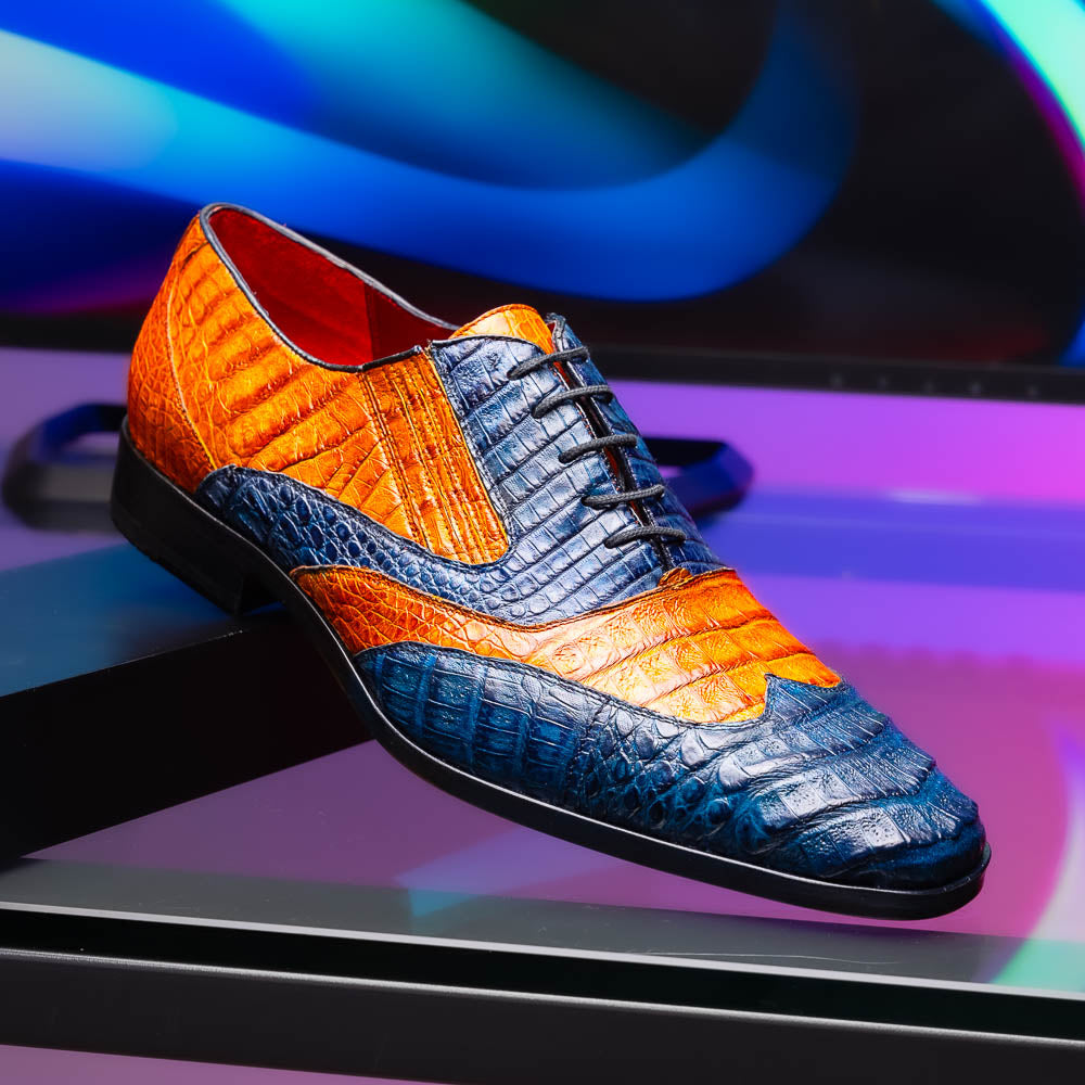 The Marco Di Milano Luciano Blue / Brandy men's dress shoes feature textured leather in orange and navy, with one shoe upright and the other on its side to display the sole.