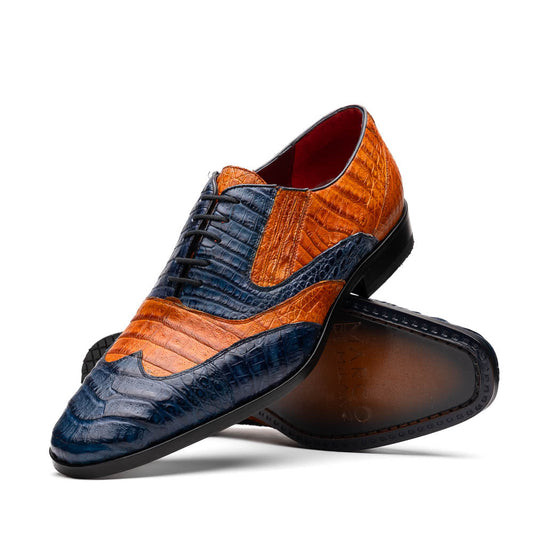 The Marco Di Milano Luciano Blue / Brandy men's dress shoes feature textured leather in orange and navy, with one shoe upright and the other on its side to display the sole.