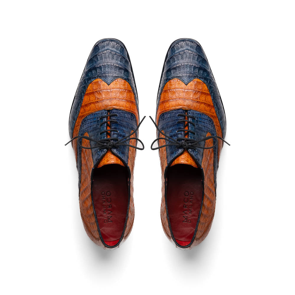 The Marco Di Milano Luciano Blue / Brandy men's dress shoes feature textured leather in orange and navy, with one shoe upright and the other on its side to display the sole.
