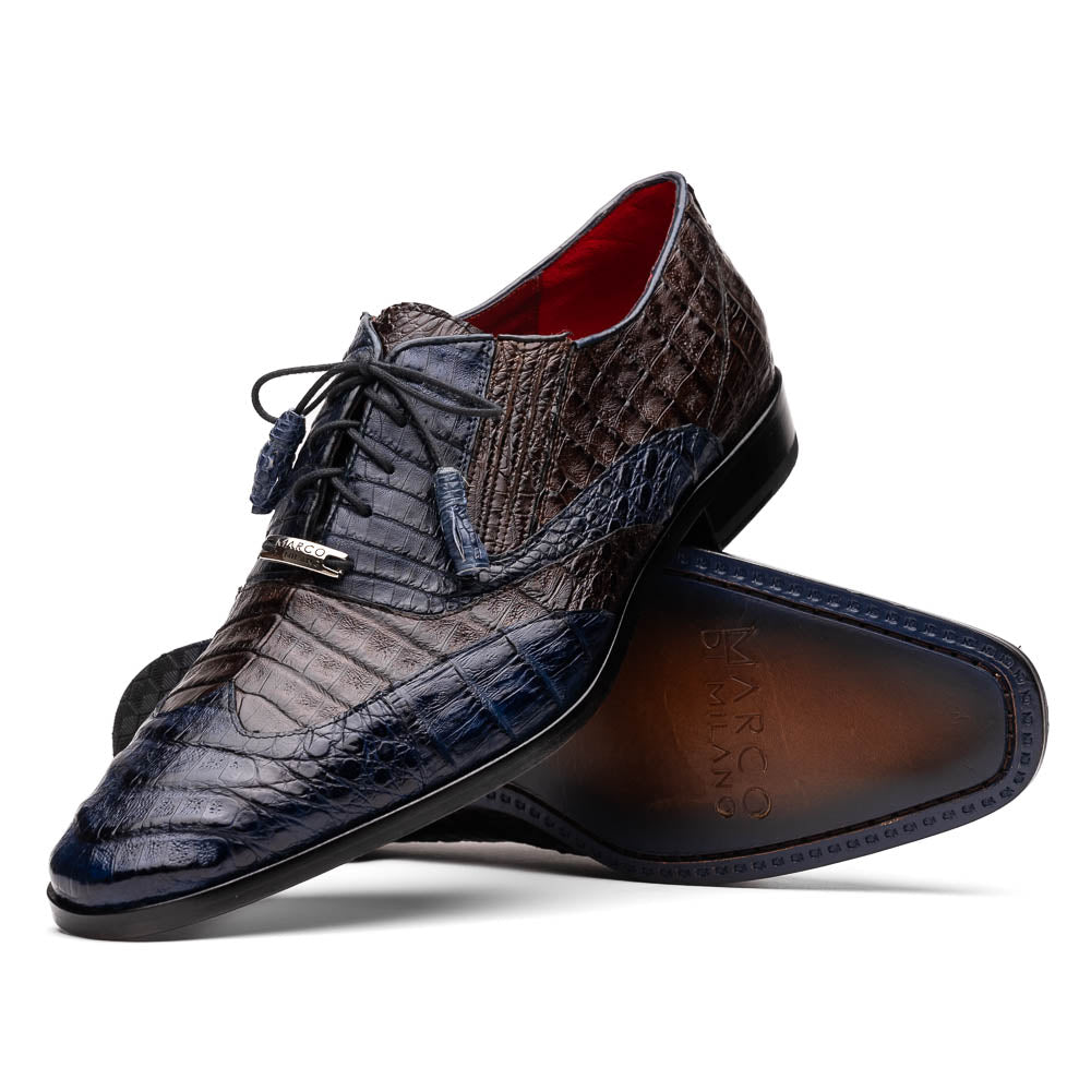 The Luciano Navy / Brown by Marco Di Milano: luxury men's wingtip derby shoes in dark blue and brown genuine caiman, shown upright and on its side to display the branded sole.