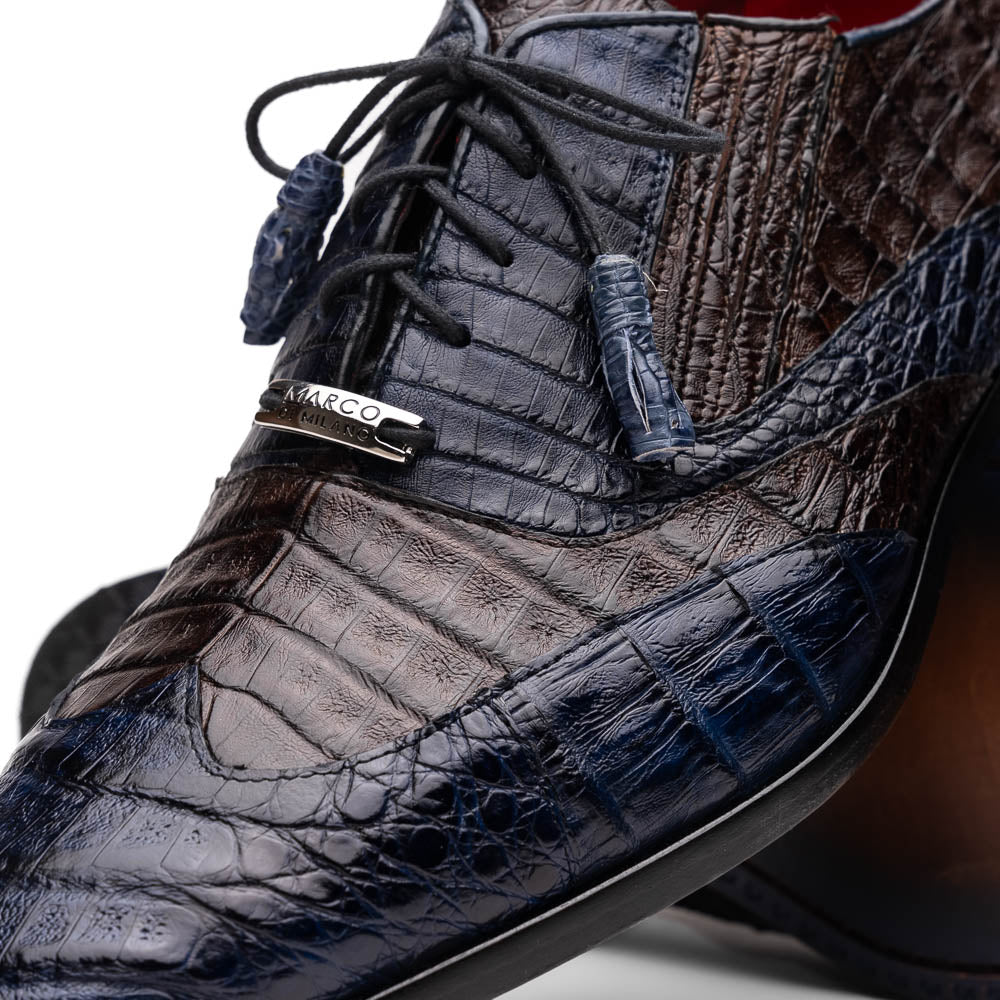 The Luciano Navy / Brown by Marco Di Milano: luxury men's wingtip derby shoes in dark blue and brown genuine caiman, shown upright and on its side to display the branded sole.