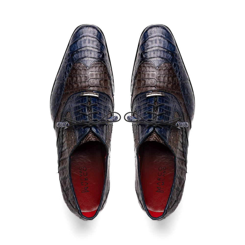 The Luciano Navy / Brown by Marco Di Milano: luxury men's wingtip derby shoes in dark blue and brown genuine caiman, shown upright and on its side to display the branded sole.