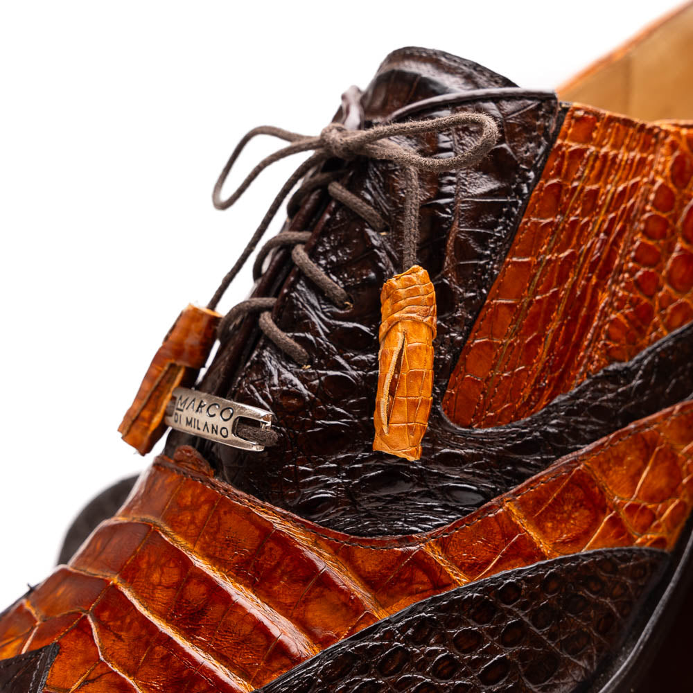 A pair of Marco Di Milano Luciano Brown / Cognac dress shoes with a pointed toe, lace-up closure, and embossed sole branding—ideal for elevating your luxury men's footwear collection.