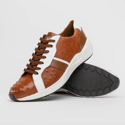 The Lyon II Brandy / White sneakers by Marco Di Milano feature a textured brown and white leather upper, white soles, and brown laces—a true statement in luxury footwear, shown against a plain white background.