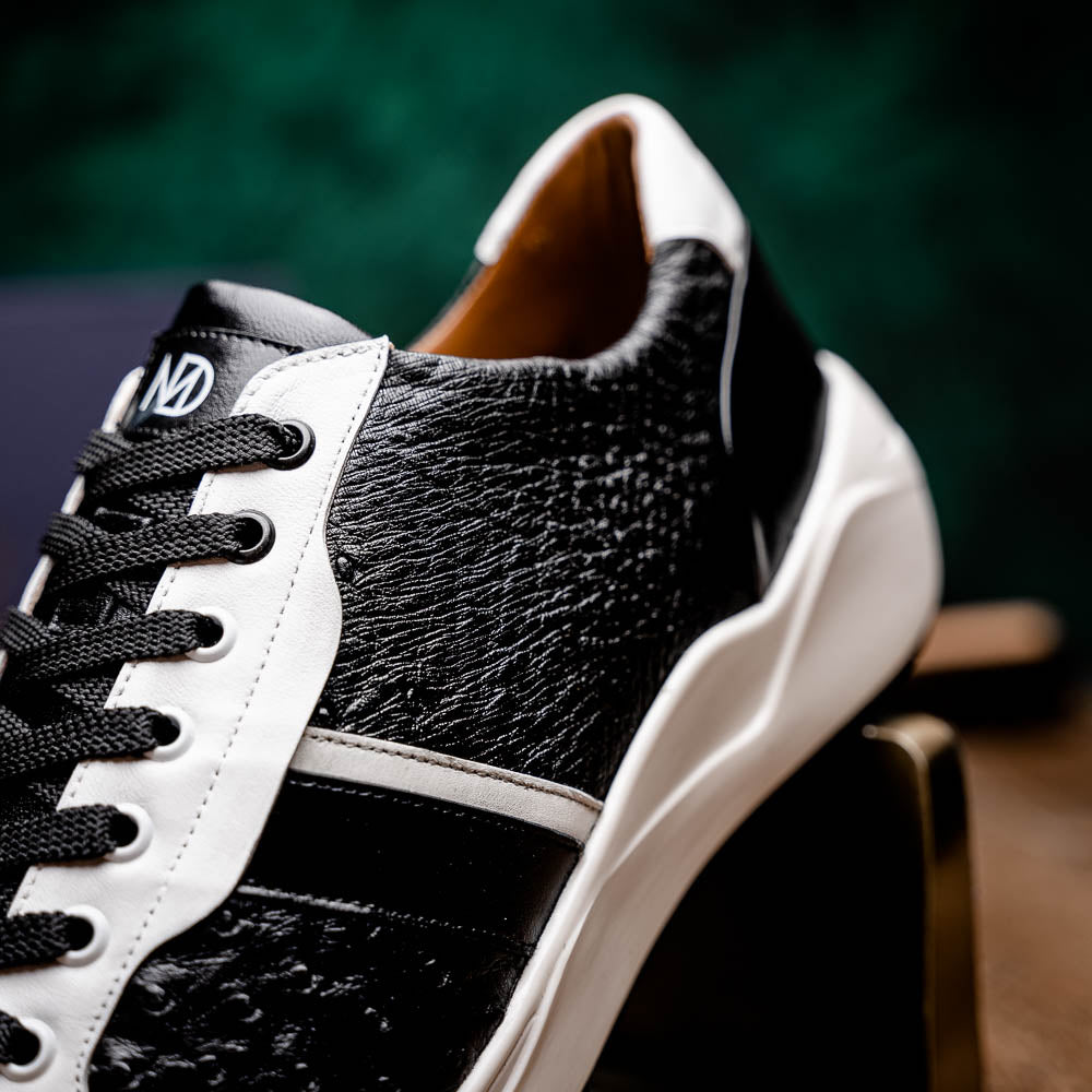 The Marco Di Milano Lyon II Black / White sneakers feature textured leather uppers, black laces, and rubber soles, displayed against a plain white background.
