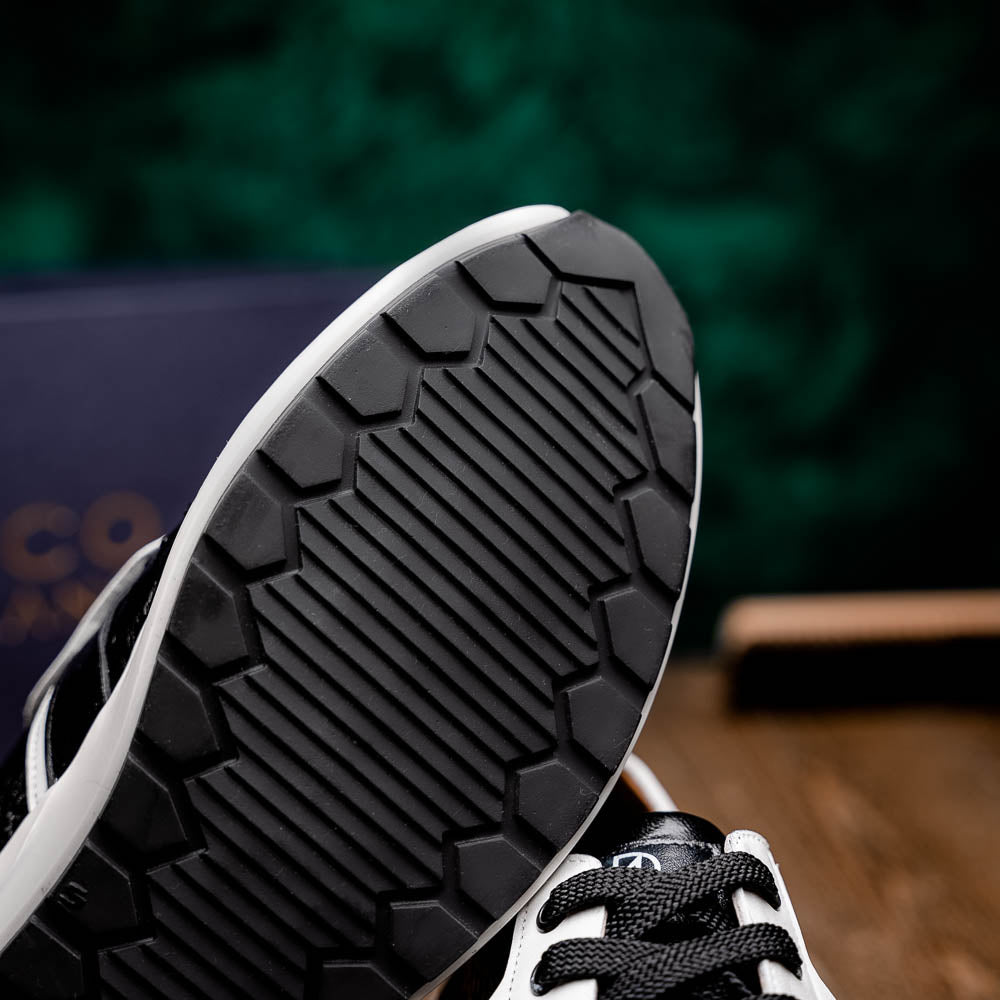 The Marco Di Milano Lyon II Black / White sneakers feature textured leather uppers, black laces, and rubber soles, displayed against a plain white background.